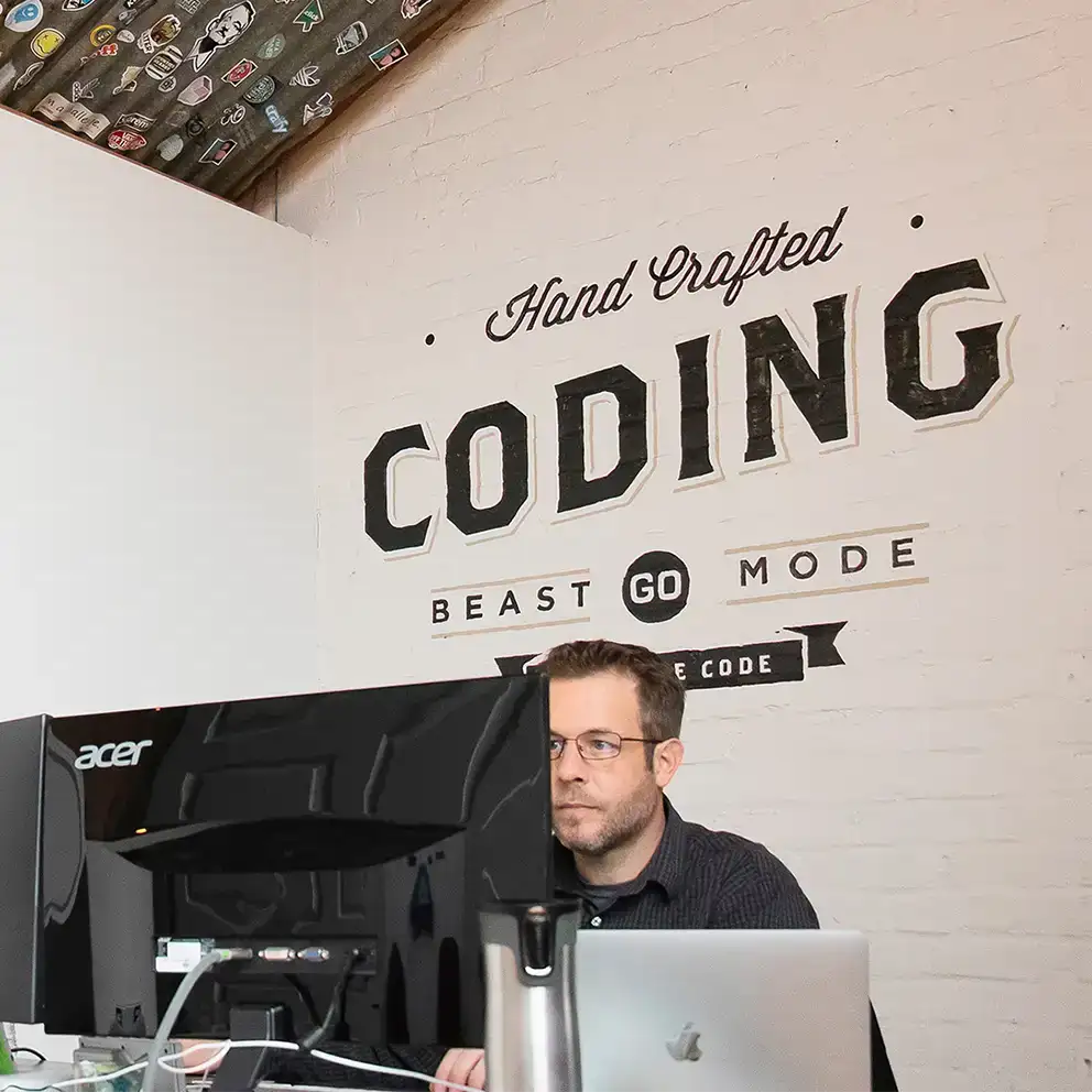 Steve sitting at desk coding