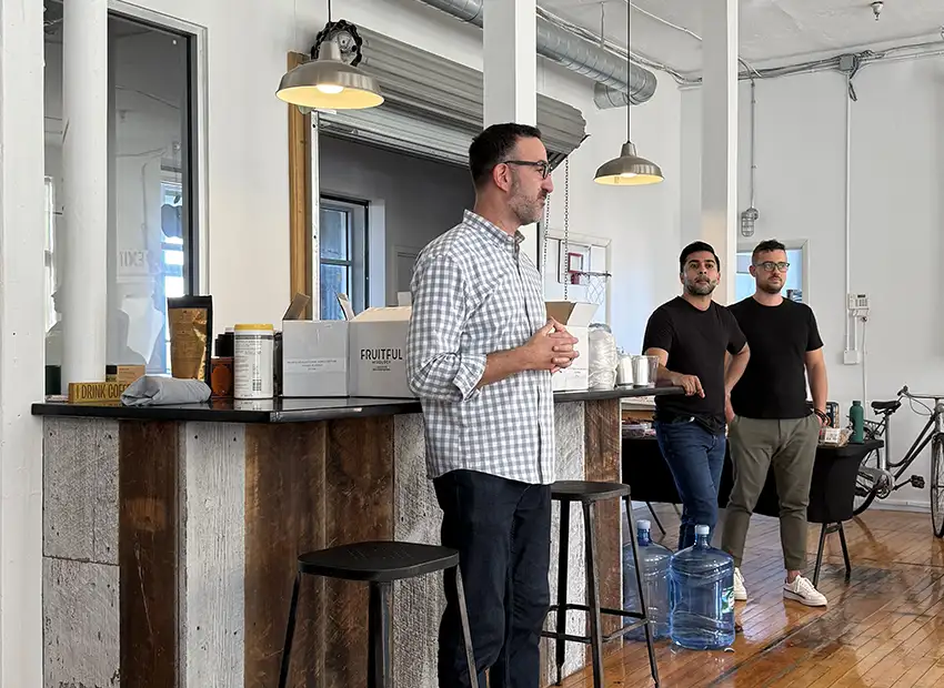 Chad talking infront of the room to introduce the Fruitful creators while GO members sit in chairs listening