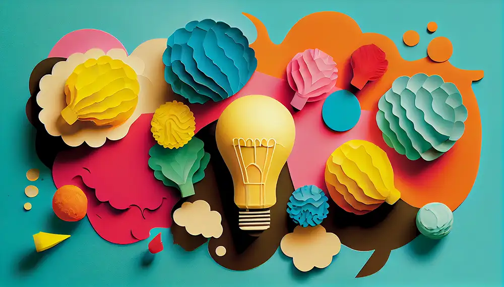 A collage of a paper lightbulb and other colorful pieces of paper